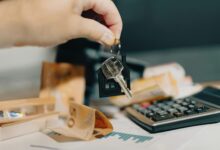 Landlord handing apartment keys to tenant over lease agreement