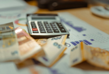 Calculator and cash representing debt and financial calculations in Texas