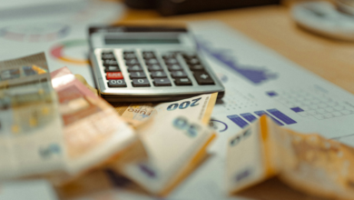 Calculator and cash representing debt and financial calculations in Texas