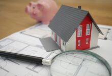 Magnifying glass over miniature house model and blueprints- Texas property tax appraisal protest guide - Texas Financial Report
