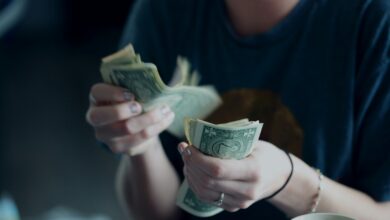 Person holding cash while counting money