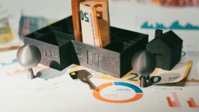 hand holding house keys beside calculator and money for mortgage escrow refund article