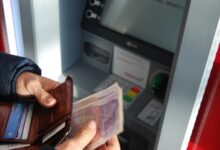 person holding cash and wallet for Texas utility deposit refund article
