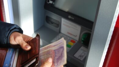 person holding cash and wallet for Texas utility deposit refund article